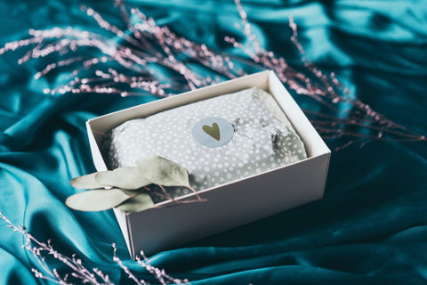 4. BONOBO gift box with polka dot wrapping and heart sticker on teal fabric