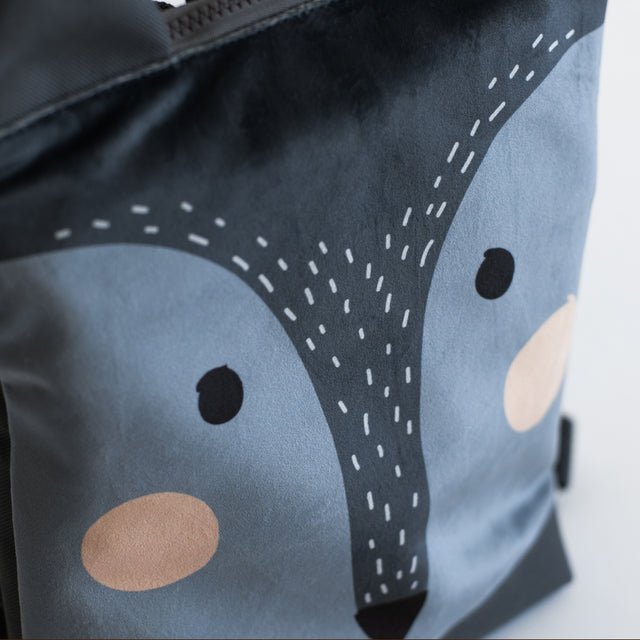 11. Close-up of Muni wolf backpack design, highlighting velvet fabric and details