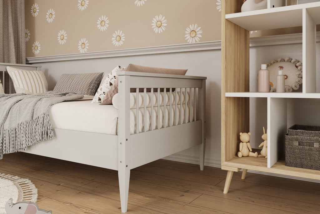 4. Close-up of gray wooden bed frame with slatted design and soft bedding