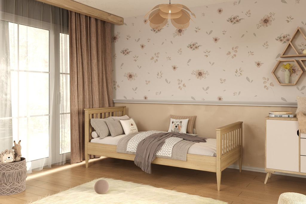 1. Natural finish wooden bed in a cozy bedroom setting with floral wallpaper and wooden flooring
