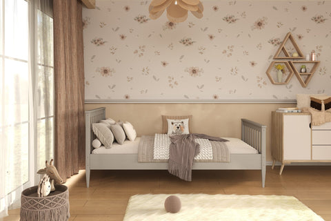 1. Gray wooden bed in a children's room with floral wallpaper and wooden flooring