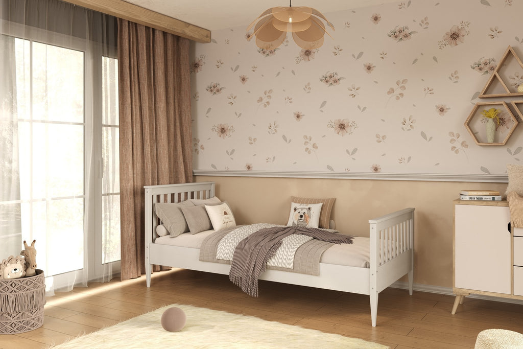 1. White wooden bed in a children's room with floral wallpaper and wooden flooring