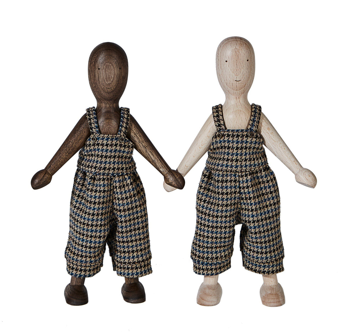 2. Two wooden beech dolls wearing checkered pants standing side by side