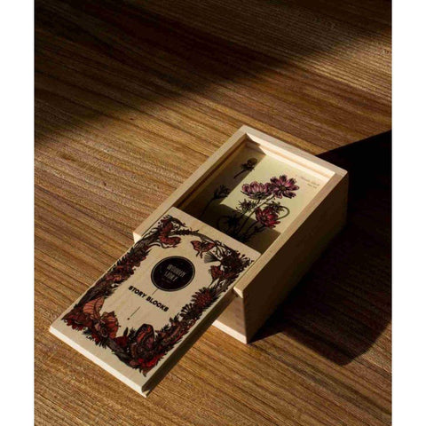 4. Wooden Story Bee Life Blocks box with plant cards inside on wooden surface