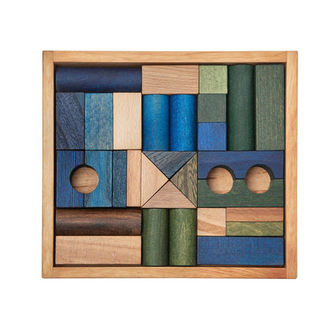 2. Wooden Story wooden blocks in shades of green, blue, and brown neatly arranged in a wooden box