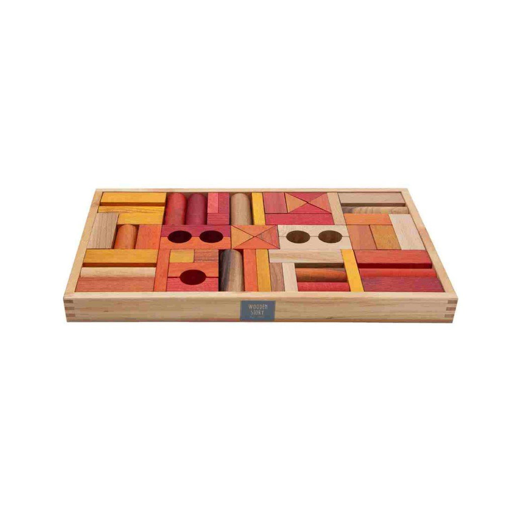 3. Close-up of Wooden Story wooden blocks in a box, featuring warm shades of red, orange, and yellow, promoting imaginative play