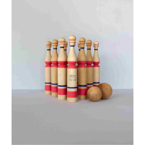 5. Set of ten red and natural wooden bowling pins with two balls on a grey background