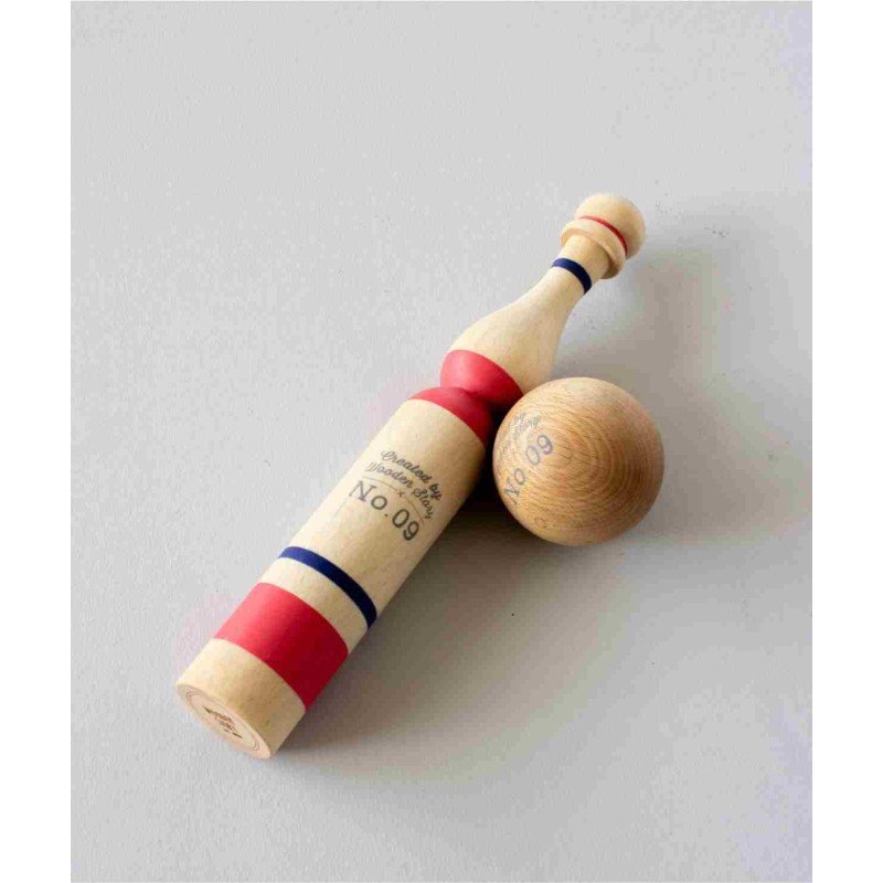 2. Single red and natural wooden bowling pin with a ball on a light grey surface