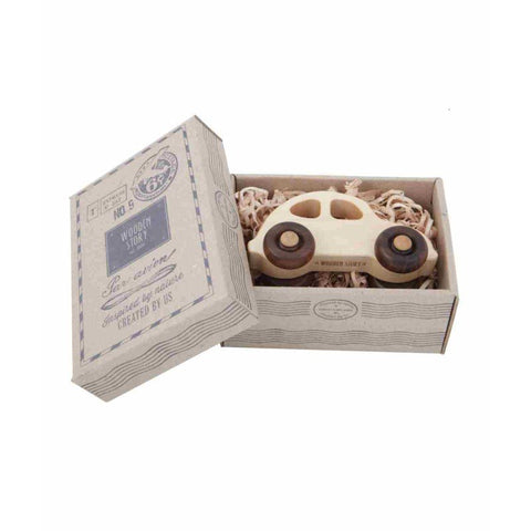 4. Flat lay of 1930s Wooden Story car in open cardboard box with decorative packaging