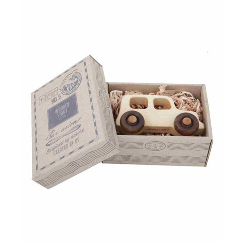 2. Wooden Story toy car in open cardboard box with shredded paper packaging