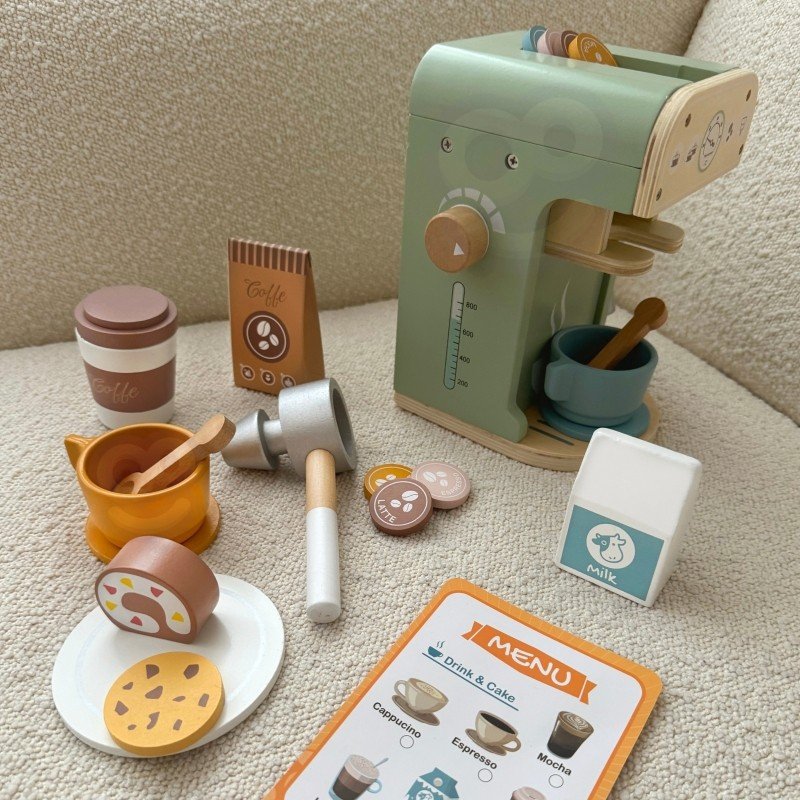 1. Woopie Green wooden barista set on textured surface with coffee machine, cups, and pastries