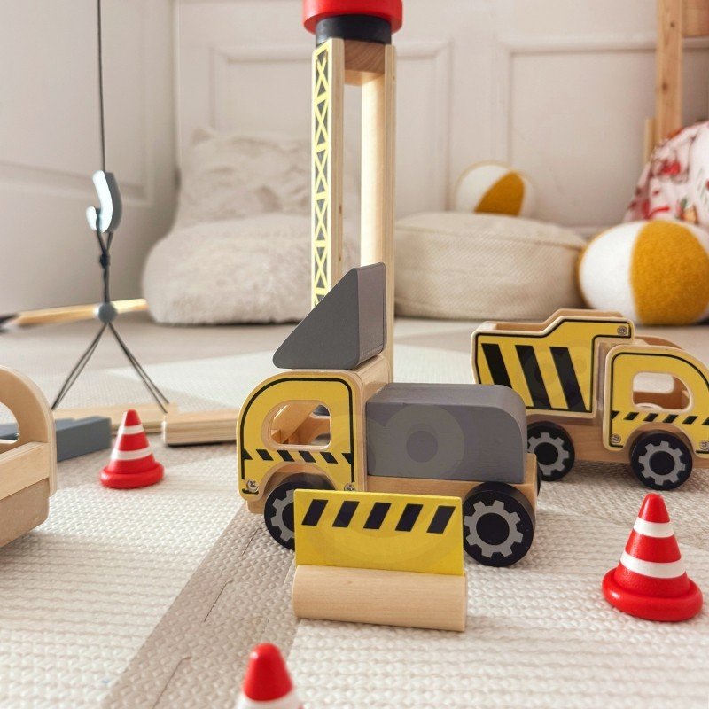 10. Close-up of Woopie Green wooden construction vehicles and crane on carpet