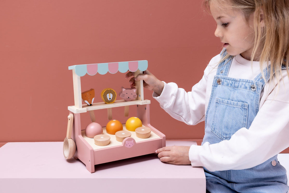 4. Child playing with wooden ice cream shop, arranging scoops and lollies