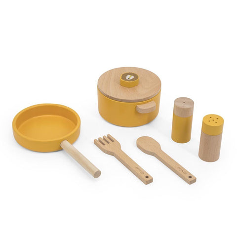 2. Studio shot of Trixie Baby Mr. Lion wooden kitchen set with yellow pot, pan, salt and pepper shakers, spoon, and fork on white background
