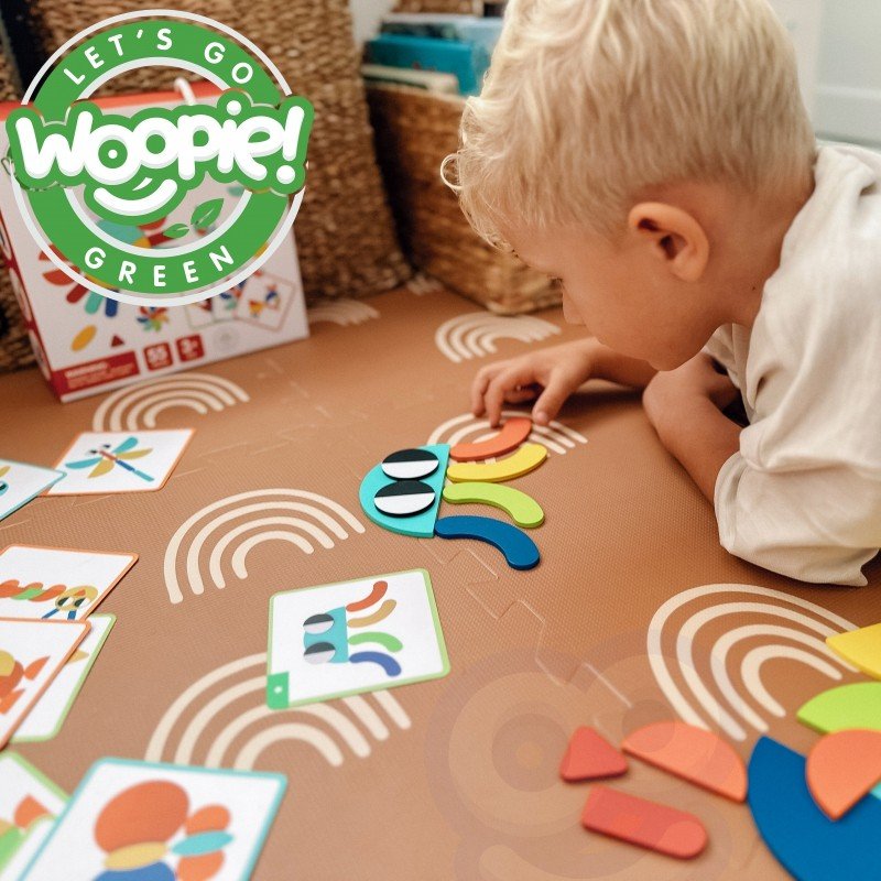 6. Child assembling colorful wooden shapes on table with Woopie Let's Go Green logo