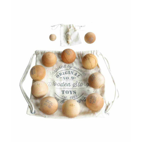 2. Flat lay of Wooden Story's wooden pétanque game set with eight wooden balls and one cochonnet on a branded drawstring bag