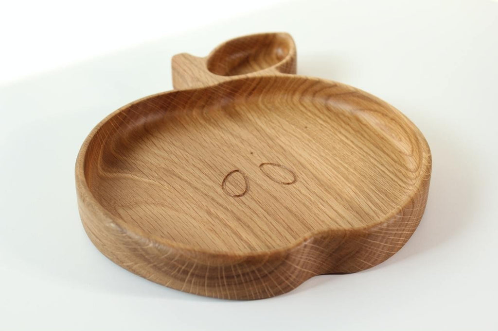 3. Angled view of wooden apple-shaped plate for kids, showcasing the smooth surface and natural wood grain