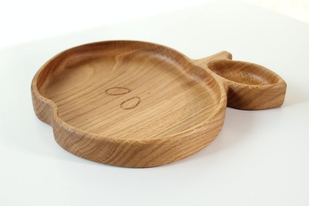 2. Side view of wooden apple-shaped plate for kids, highlighting the depth and smooth finish, on a white background