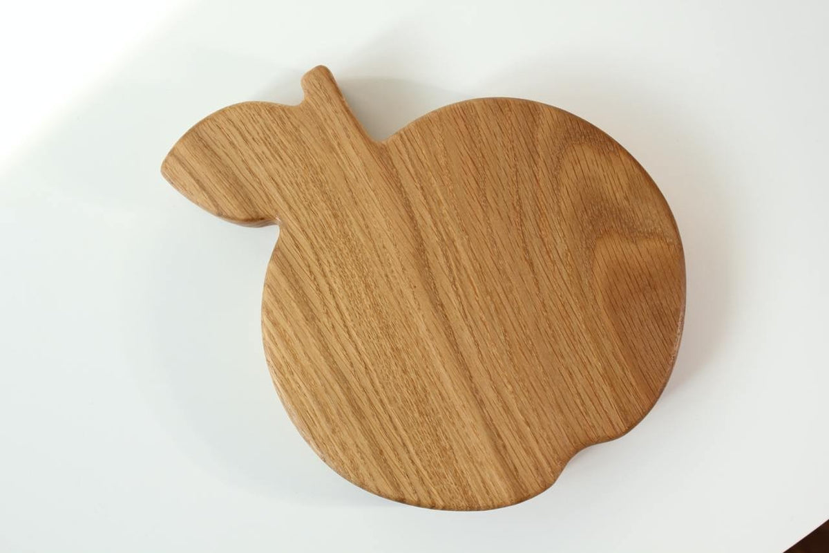 6. Back view of wooden apple-shaped plate for kids, highlighting the natural wood grain and smooth finish