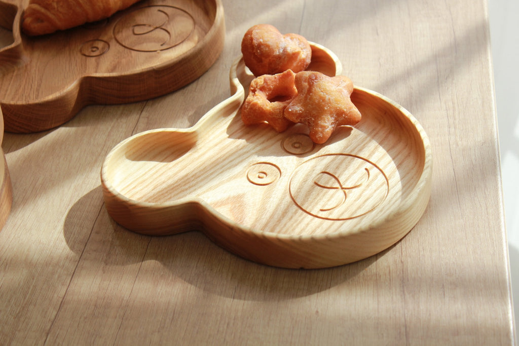 8. Wooden bear-shaped plate with star-shaped snacks, on wooden surface with natural light
