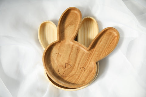 4. Oak and ash wooden bunny plates on a white fabric background