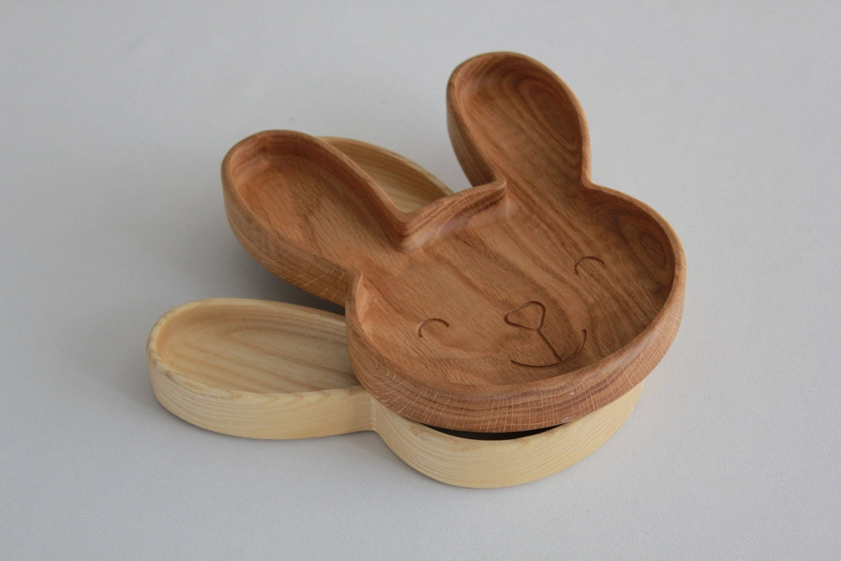 7. Stacked oak and ash wooden bunny plates on a white background