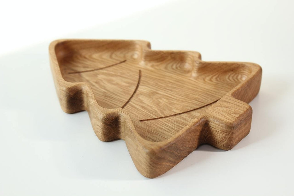2. Studio shot of a wooden Christmas tree-shaped plate made from oak or ash, showcasing its smooth surface and natural grain