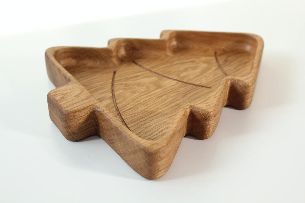 4. Angled view of a wooden Christmas tree-shaped plate, emphasizing the depth and natural wood texture