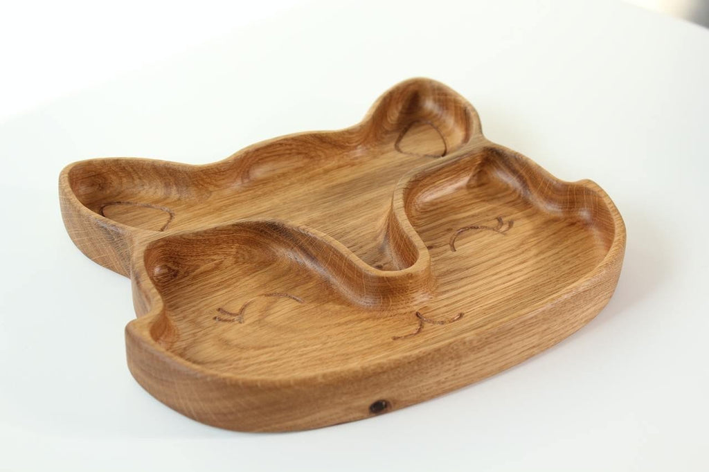 7. Perspective view of wooden fox-shaped plate with two sectors, showing engraved eyes and smooth surface on white background