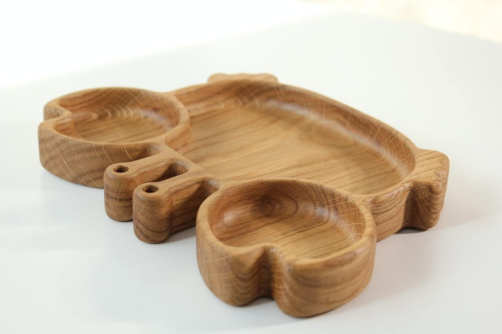 3. Side view of oak wooden crab-shaped plate for kids, emphasizing the depth and smooth edges of the compartments