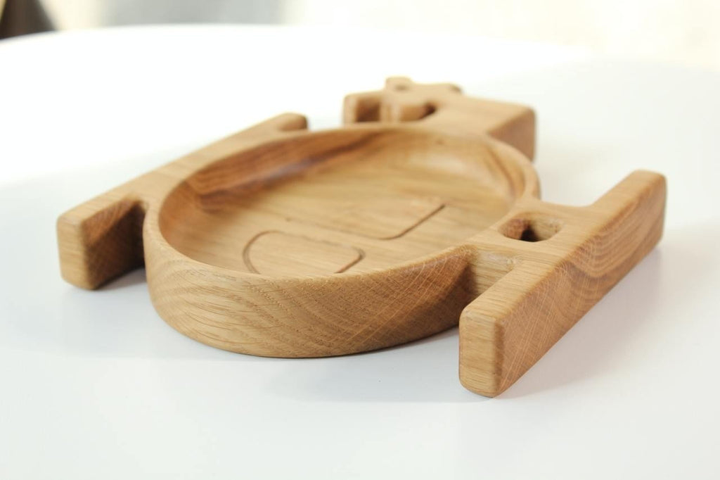 9. Side view of a wooden helicopter-shaped plate for kids, showcasing the smooth finish and natural wood grain, on a white background