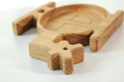 3. Close-up of the tail section of a wooden helicopter-shaped plate for kids, highlighting the smooth finish and natural wood grain