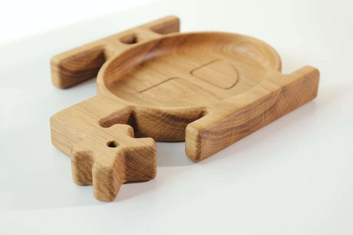 6. Angled view of a wooden helicopter-shaped plate for kids, highlighting the smooth finish and natural wood grain, on a white background