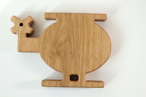 5. Flat lay of a wooden helicopter-shaped plate for kids, showing the back side with natural wood grain, on a white background