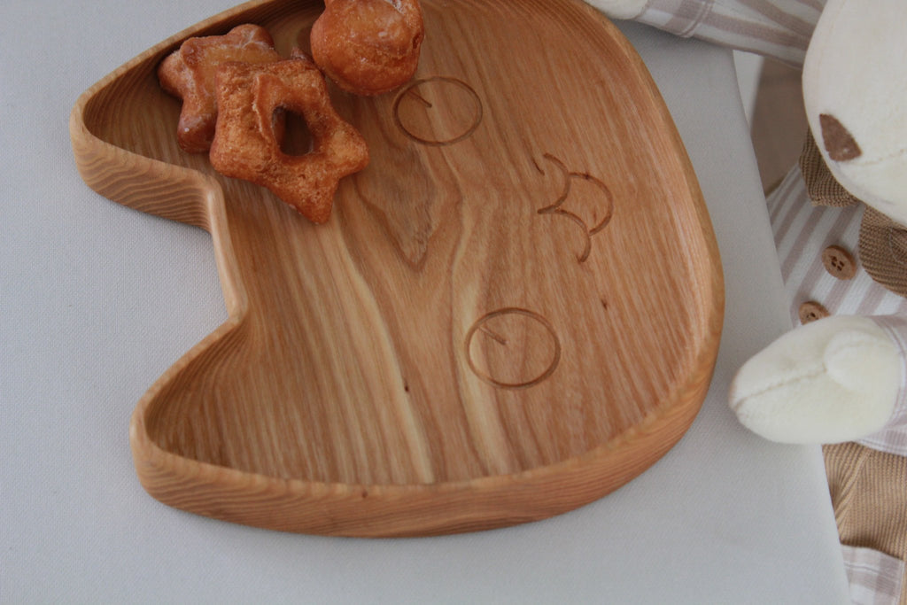 3. Close-up of wooden cat-shaped plate with pastries, highlighting smooth, polished surface