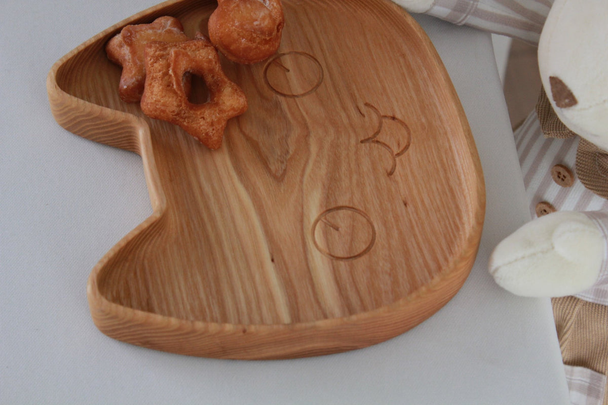 3. Close-up of wooden cat-shaped plate with pastries, highlighting smooth, polished surface