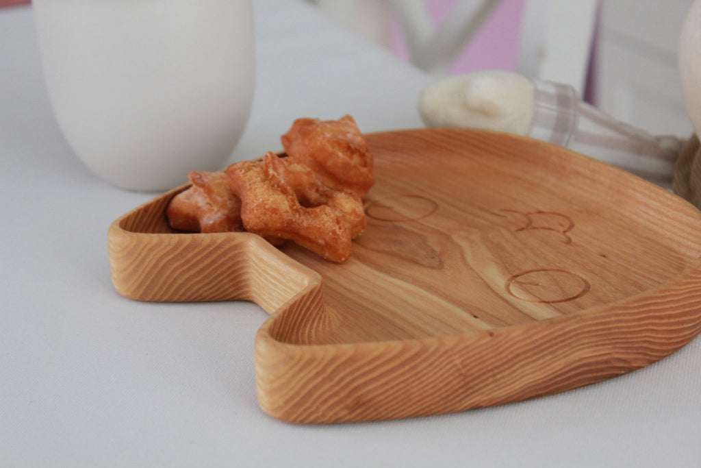 3. Close-up of wooden cat-shaped plate with food-safe wax finish, featuring carved facial details