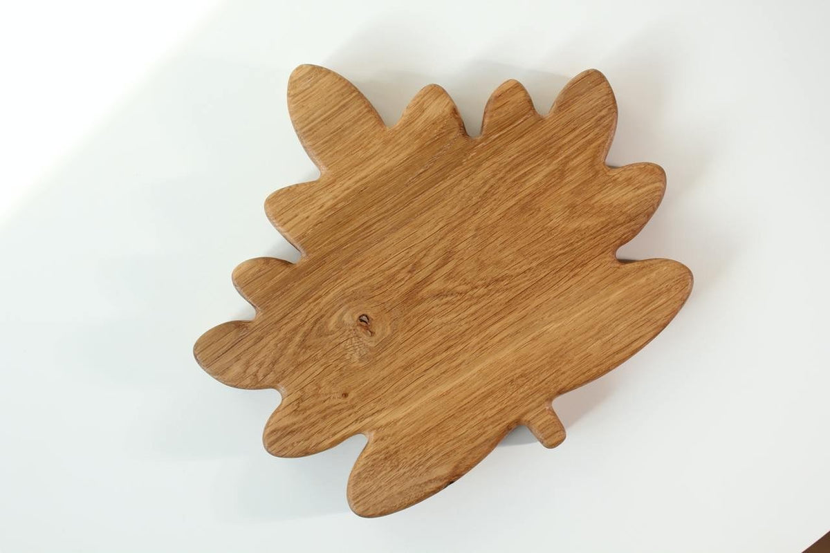 4. Flat lay of the back of a wooden plate for kids, showcasing the natural wood grain and maple leaf shape