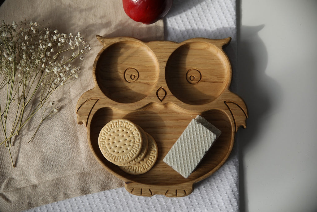 1. Handmade wooden owl-shaped plate with cookies and wafer on a textured cloth background, featuring natural oak or ash wood