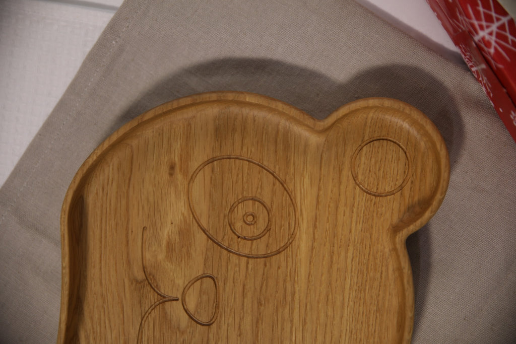 5. Close-up of wooden panda-shaped plate for kids highlighting engraved face details