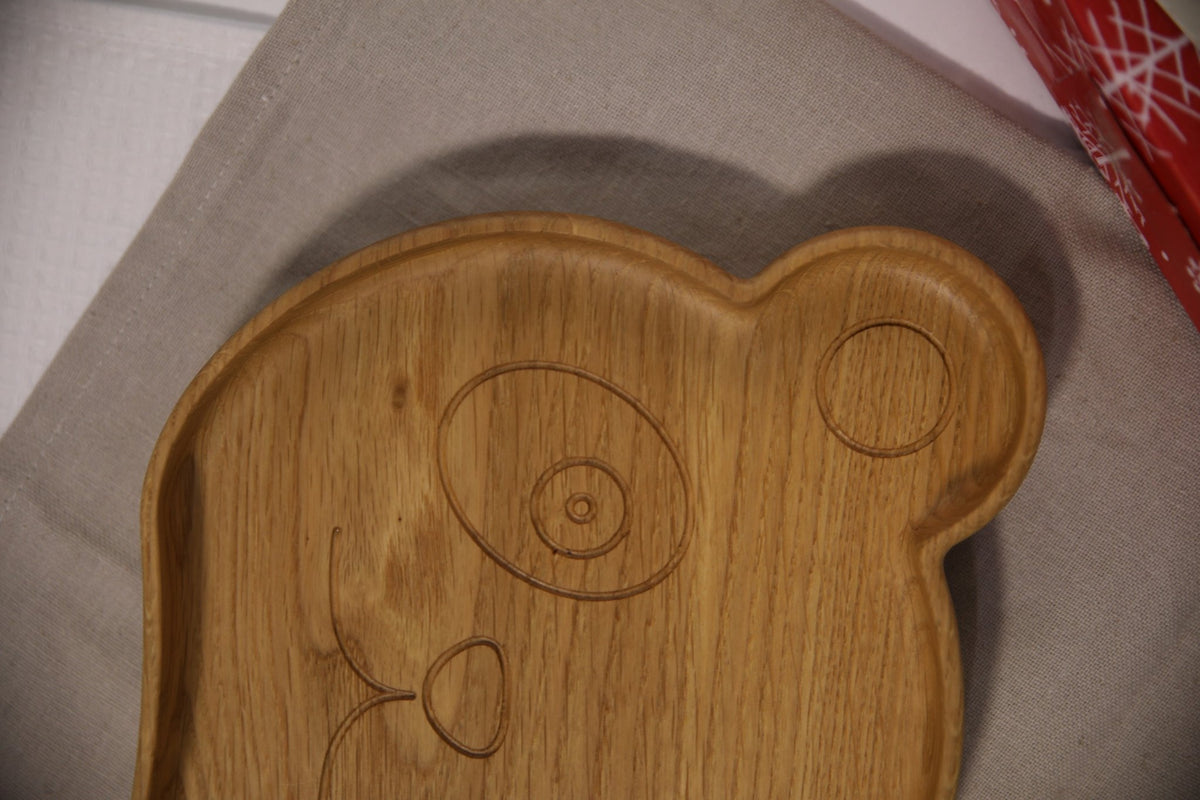 5. Close-up of wooden panda-shaped plate for kids highlighting engraved face details