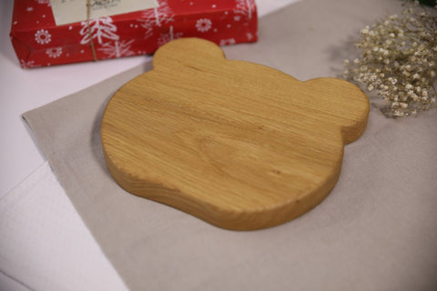 4. Flat lay of wooden panda-shaped plate for kids showing back on beige cloth