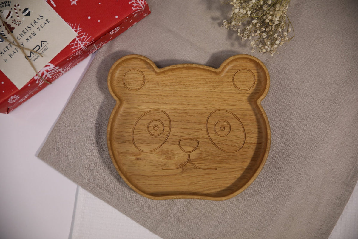 1. Handmade wooden panda-shaped plate for kids on beige cloth with red gift box and flowers