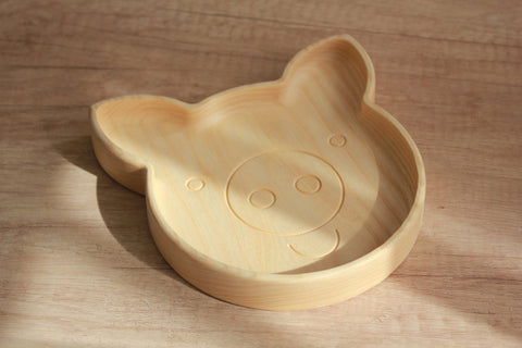 4. Light wood pig-shaped plate on wooden surface, highlighting smooth finish