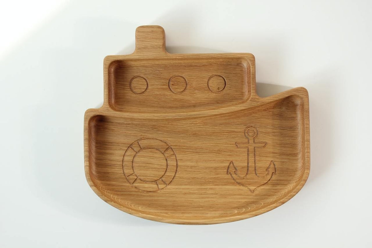 1. Handmade wooden ship-shaped plate for kids with engraved anchor and lifebuoy, made from oak or ash, on a white background