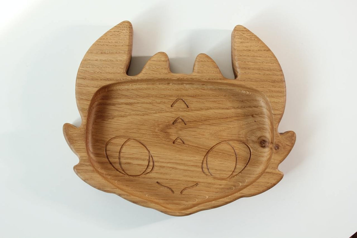 3. Close-up of handmade wooden kids plate shaped like a character face, crafted from oak wood, on a white background