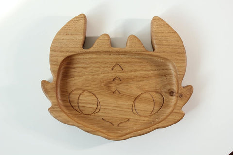 3. Close-up of handmade wooden kids plate shaped like a character face, crafted from oak wood, on a white background