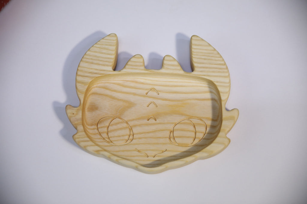 1. Handmade wooden kids plate shaped like a character face, made from light oak or ash wood, shown on a white background