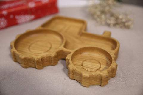 2. Close-up of wooden tractor-shaped plate highlighting smooth, polished surface and detailed wheel design