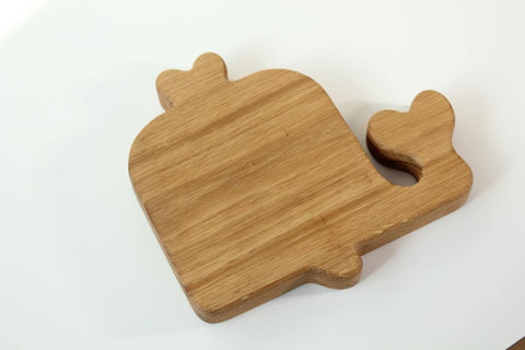2. Back view of a wooden whale-shaped plate for kids, displaying the smooth, polished surface and natural wood grain on a white background.